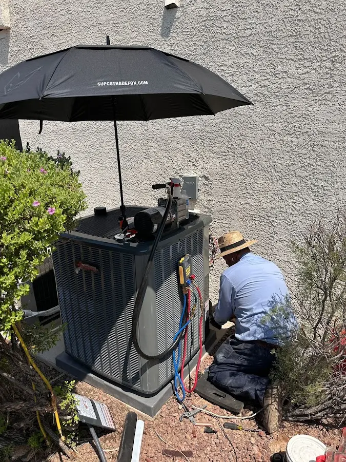 HVAC technician performing outdoor AC maintenance in Cave Creek